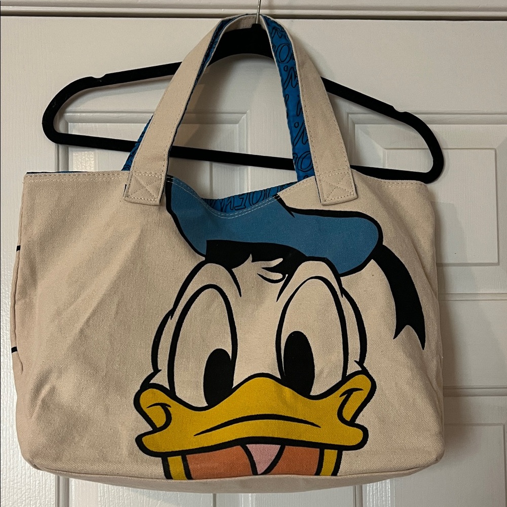 GUC Disneys Donald Duck canvas tote bag. Lined with interior zipper pocket.